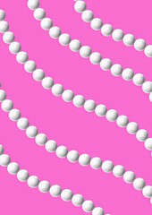 White beads on pink background arranged in wavy pattern  