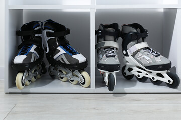 Pairs of roller skates in shelving unit, closeup