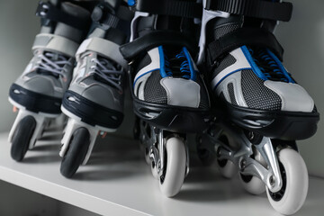 Pairs of roller skates in shelving unit, closeup