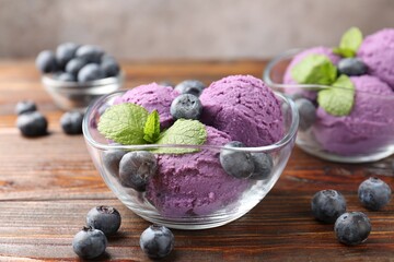 Tasty sorbet with blueberries and mint served on wooden table, closeup