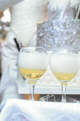 January 28, 2023 - Belgrade, Serbia. A three-tier birthday cake with silver decorations and the famous Chardonnay Brut Dargent. Cutting the cake and opening the champagne.