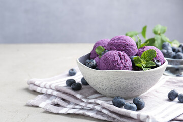 Tasty sorbet with blueberries and mint on light grey table, closeup. Space for text