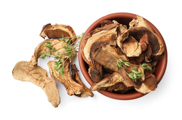 Pieces of dried mushrooms and rosemary in bowl isolated on white, top view