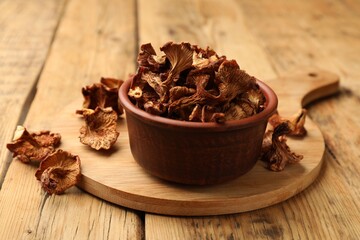 Dried chanterelle mushrooms on wooden table, closeup
