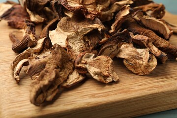Dried chanterelle mushrooms on wooden board, closeup