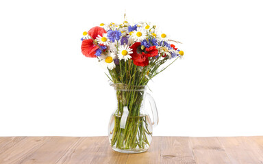 Beautiful wildflowers in vase on wooden table against white background