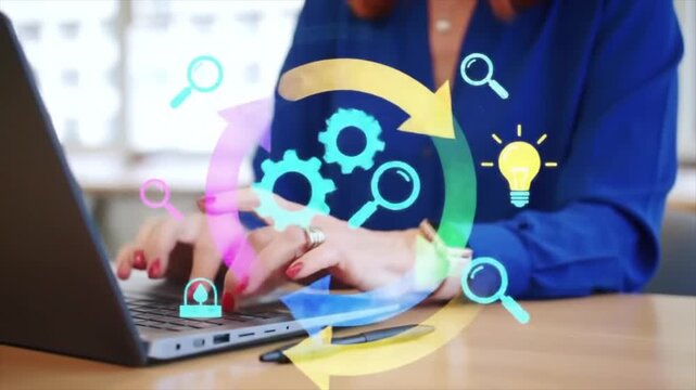 A business professional with red hair types on a laptop in a bright office. Colorful graphics representing innovation, strategy, and analytics surround the workspace, creating an engaging atmosphere