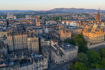 Aerial image of Edinburgh cityscape featuring Medieval Architectural buildings at Sunrise. 