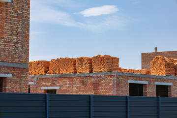 Workers are preparing for brick installation at a construction site where walls are being built...