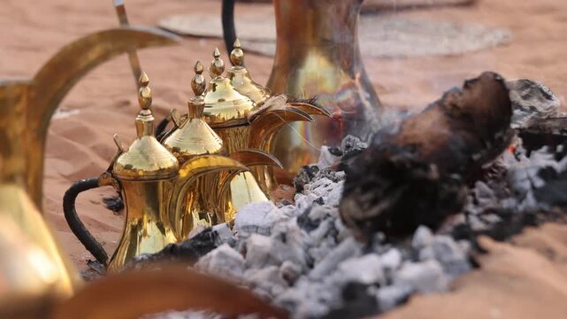 Traditional coffee pots on a fire, hospitality beverage in Arabic culture, UAE heritage concept