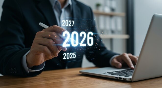 Businessman using laptop with futuristic graphic of the years 2025, 2026, and 2027.