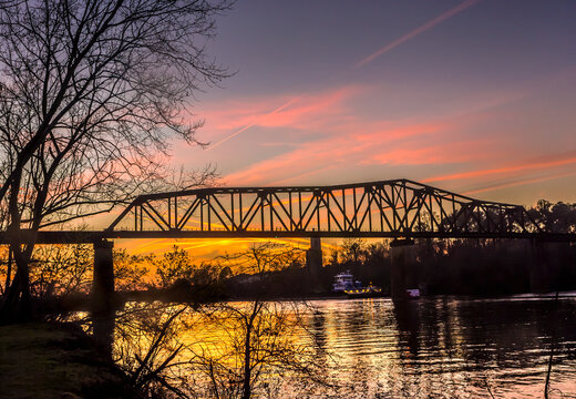 Sunset on the Tuscaloosa Northport M&O railroad trestle as viewed from the riverwalk in Tuscaloosa Alabama