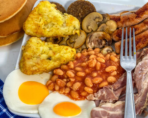 fried eggs with bacon and vegetables