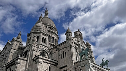 The breathtaking splendor of the bright white domes of the iconic Sacré-Cœur Basilica, located on...