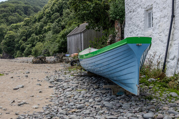 Rowing skiff sitting on a pebble beach waiting for a crew in England.