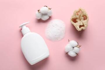 Flat lay composition with bottle of liquid soap and cotton flowers on pink background
