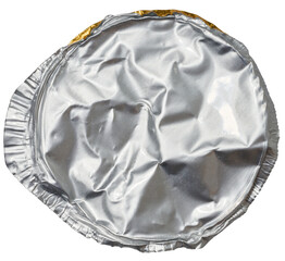 A crumpled, round, silver aluminum foil lid, viewed from above, isolated background