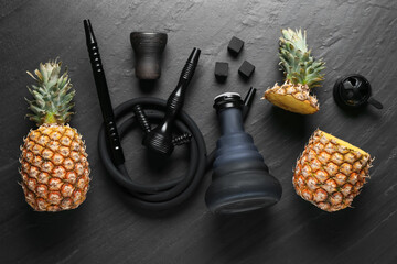 Hookah, coal and pineapples on black table, flat lay