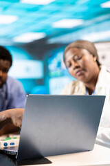 Medical expert explaining scans to team of nurses interns in the office, combining advanced...