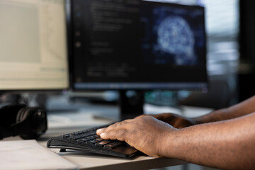 Engineer typing on keyboard, doing data center automation using AI and machine learning tools....