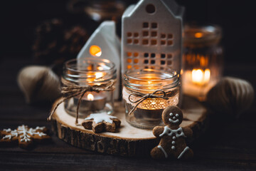 Creative handmade christmas home decor decorations: simple glass jars with aroma candles decorated with a ribbon, cinnamon, anise, dry orange. Cozy atmospheric composition for holiday mood creation