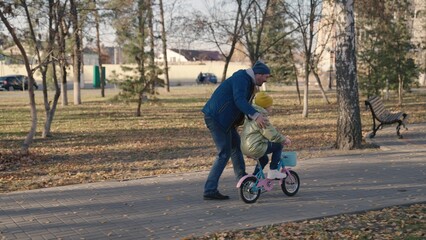 joyful father teache little child ride two-wheeled bike happy family, childhood dream drive...