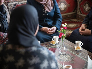 Tea service scene with small flower vase and traditional carpet in Middle Eastern interior setting