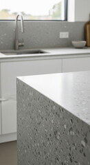 Close-up of gray terrazzo countertop texture, showcasing smooth surface and speckled design, ideal for modern kitchen or interior design concepts, offering blank space