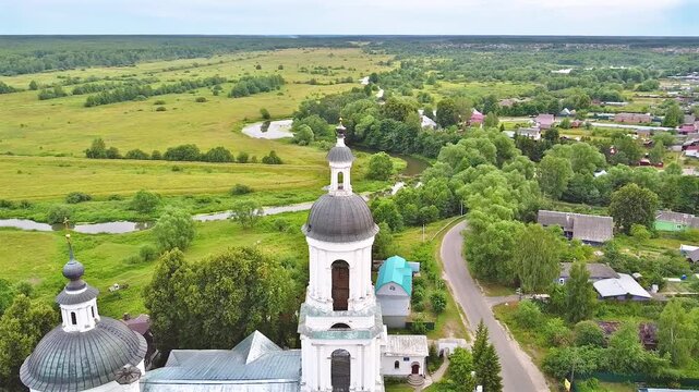 Landscape with orthodox church with fields under gloomy sky