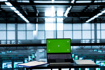 Green screen mockup laptop in empty data center used to run security patches. Isolated screen...