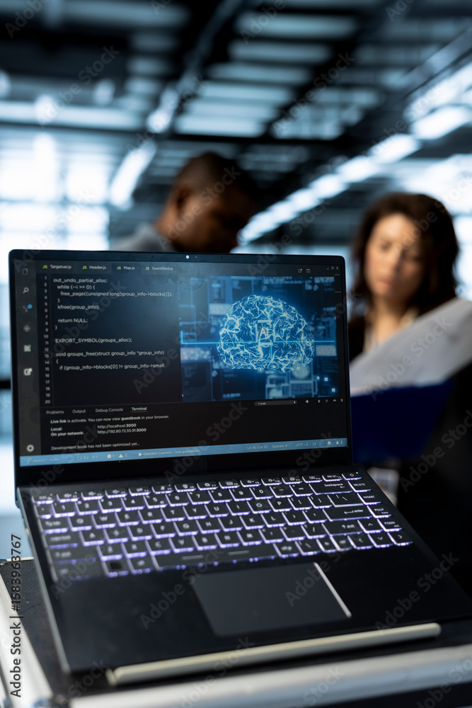 Poster focus on laptop used by teamworking data center computer scientists in blurry background using artif