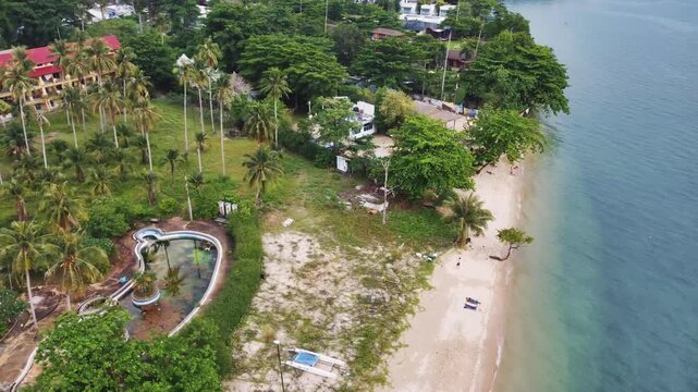 Drone view of amazing white sand beach blending with turquoise waters, palm trees