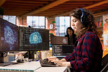 AI industry startup technician coding and listening music in office. Silicon Valley company...