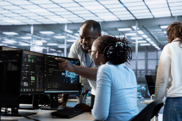 Manager coming to engineer desk to give instructions on doing maintenance on artificial...