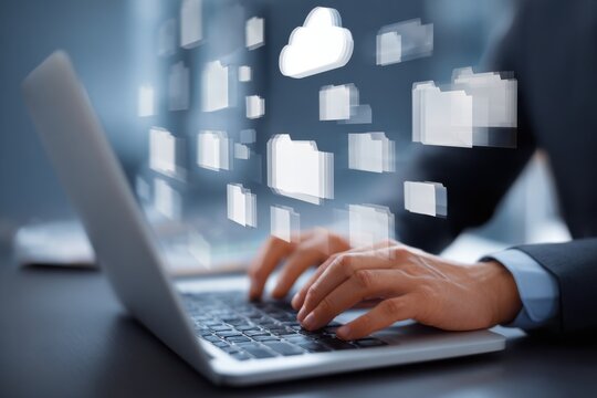Businessman downloading computer files or installing software on a laptop computer, cloud storage technology, data backup, cyber security