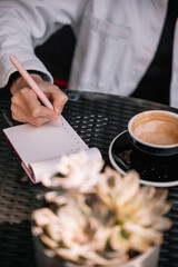 Capturing thoughts while enjoying coffee and a quiet moment outdoors