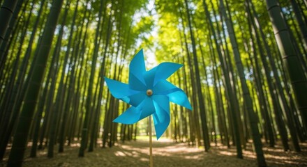 A blue pinwheel stands in a bamboo forest, blades facing forward.