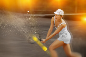 Young woman playing tennis against female opponent on tennis court
