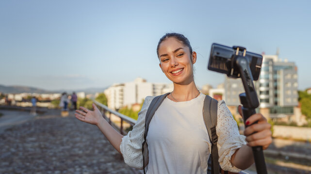 woman tourist v-logger on live stream and show landmark to followers