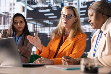 Group of influential businesswomen discussing financial strategies, embodying corporate leadership...