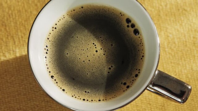 Cup of invigorating freshly brewed coffee on the table. Close-up of chicory drink. High quality 4k footage