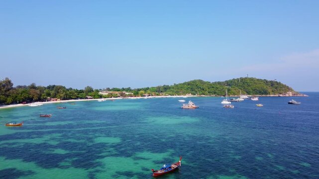 aerial view of beautiful crystal clear water and white sand beach with long tail boats