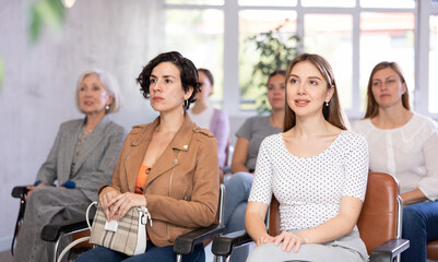 students sit in lecture center and listen intently to teacher s story about composition of theory...