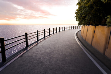 夕日がキラキラ海面に反射するガードレールがある海沿いの道
