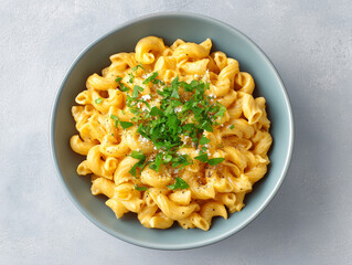 Creamy mac and cheese served in a blue bowl with herbs, showcasing a delicious homemade meal for comfort food lovers