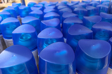Bright blue caps of various products line the shelves in a vibrant store display
