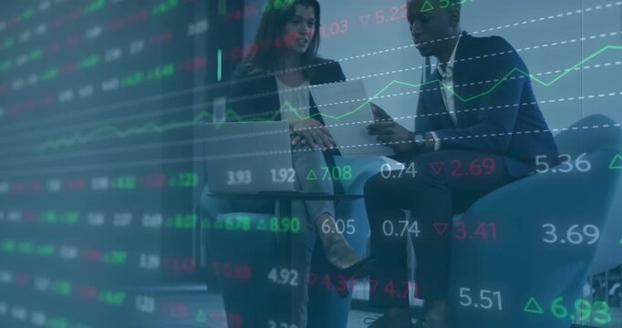 Woman opening laptop and scrolling financial data while man tapping phone reviewing chart overlays - Powered by Adobe