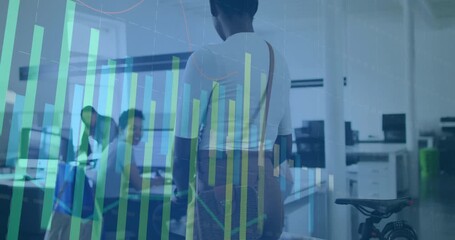 Commuter entering office, activating green commute chart while colleagues testing saddle