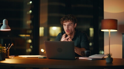 Angry ceo quarrelling virtual conference at night office. Nervous businessman