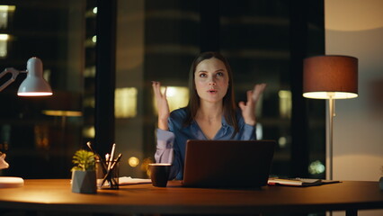 Successful employee talking virtual conference sitting dark company office. 